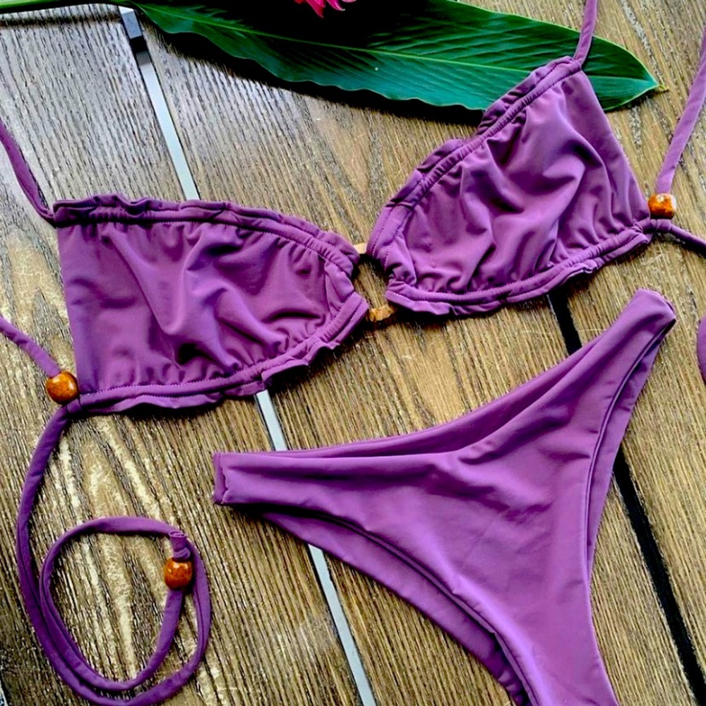 2 handmade bikinis made in a tropical island. Both purple and perfect summer